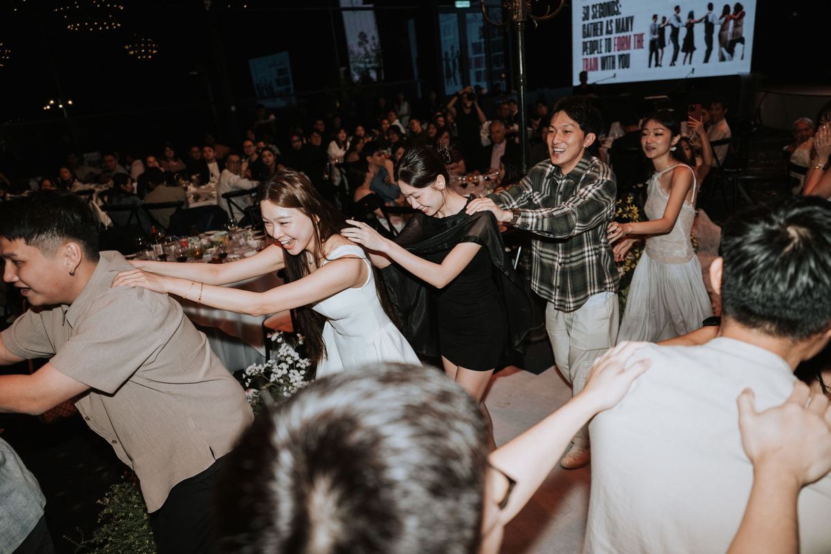 Guests joining a fun train game on the dance floor