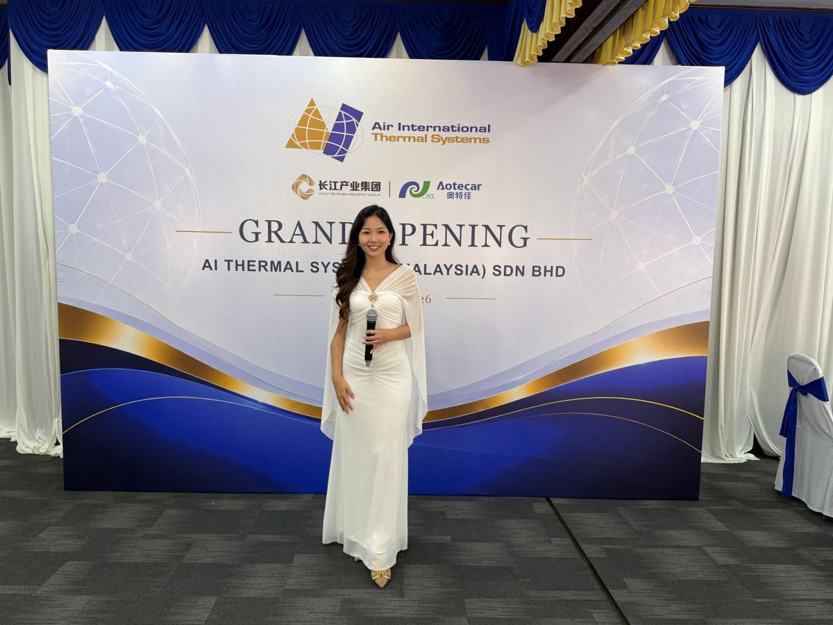 Hosting in front of the Aotecar Group Plant Opening backdrop