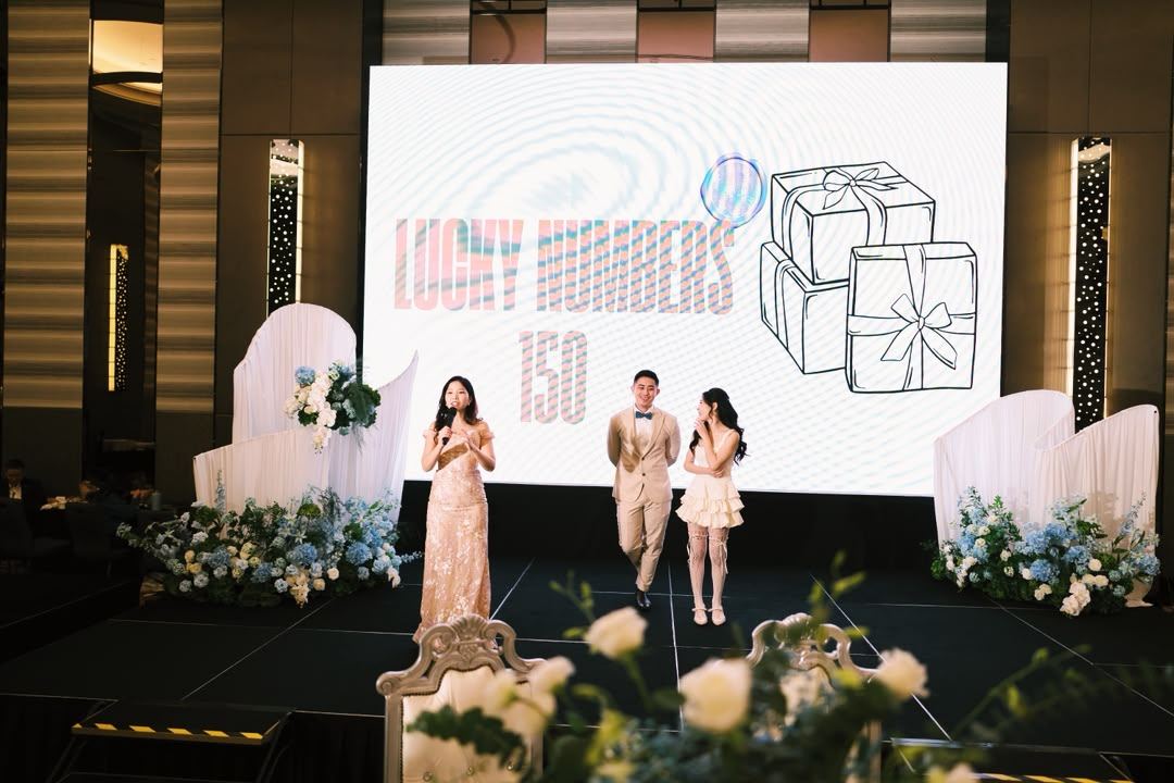 Hosting the lucky draw on stage at a celebration
